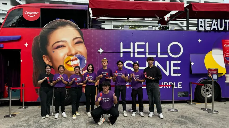 Baito’s Colgate Purple Squad crew in front of the Hello Shine roving bus.