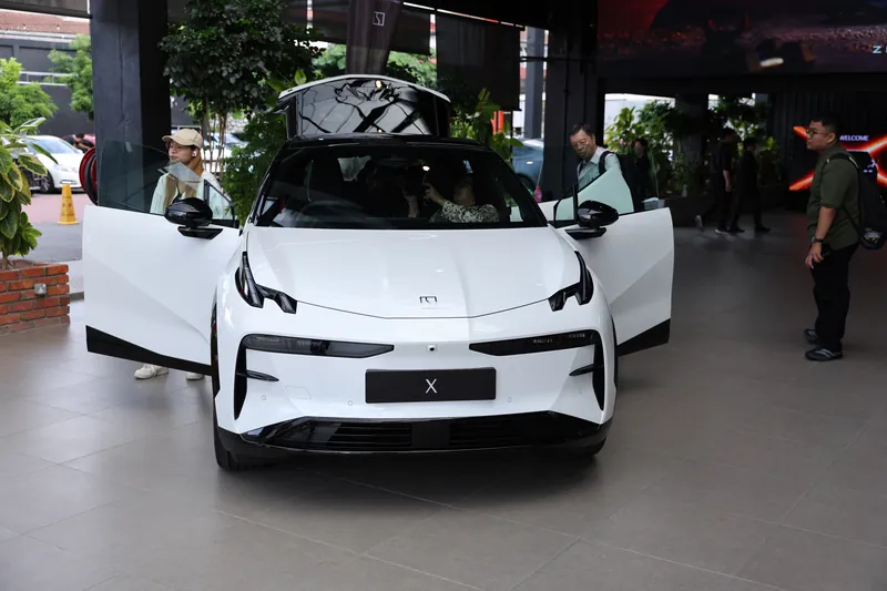 Guests exploring a white ZEEKR X with its doors and tailgate open at the launch